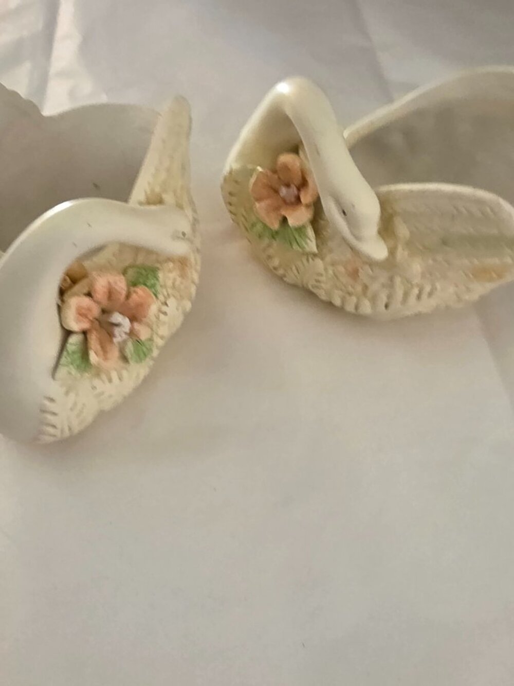 These vintage ceramic swan trinket dishes feature a charming design with roses